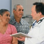 man in white button up shirt holding white tablet computer