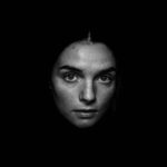 grayscale photography of woman looking straight