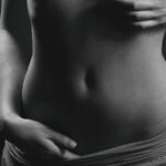 a black and white photo of a woman's stomach