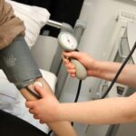 A person with a blood pressure device in their hand