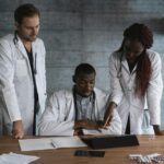 Doctors in discussion at a medical clinic, working on patient treatment plans.