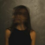 a blurry photo of a woman in a black top