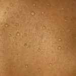 A man's back with water drops on it