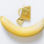 Image of a banana and a condom, symbolizing health education and safe sex practices.