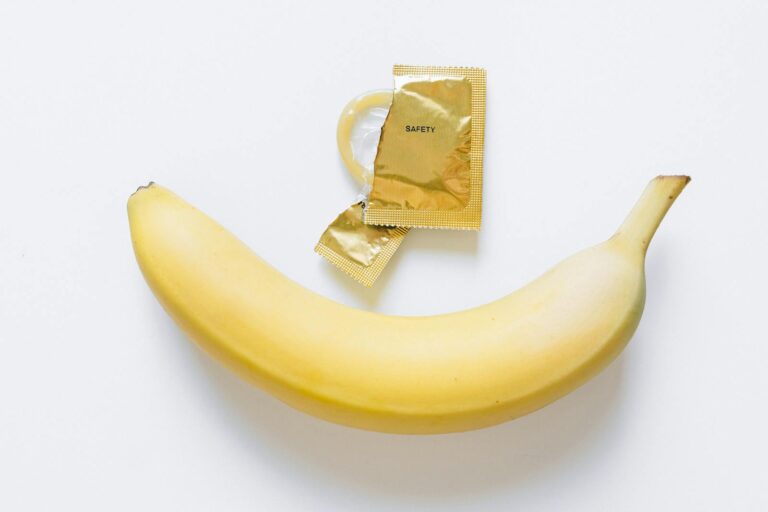 Image of a banana and a condom, symbolizing health education and safe sex practices.