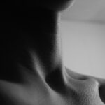 a black and white photo of a woman's neck