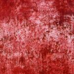 a red wall with a lot of rust on it