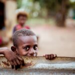 boy holding corrugated sheet