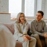 A couple and therapist engaged in a discussion during a therapy session indoors.