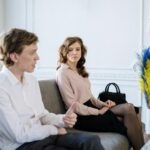 A couple engaging in a therapy session in a stylish, modern office setting.